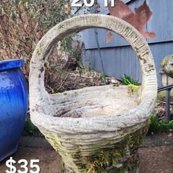 Concrete plant pot that looks like a basket with a handle 