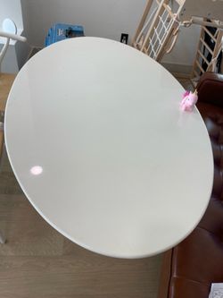 White dining table, pink love seat and 2 white chairs