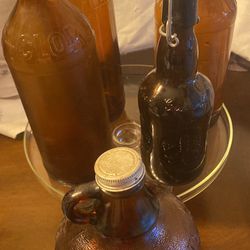 4 Vintage Amber Fleecy White And Clorox Bottles And 1 Beer Bottle 
