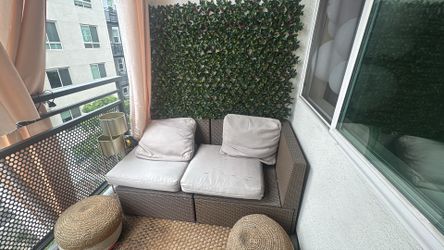 Outdoor IKEA chairs with artificial green panel