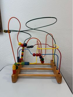 (1) Vintage Anatex Original Rollercoaster is a classic wooden bead maze designed to promote hand-eye coordination and color recognition in young child