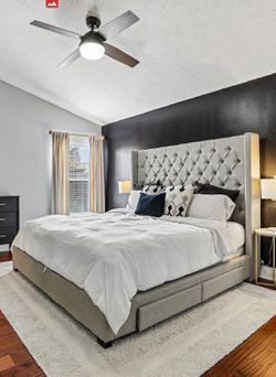 Gray upholstered king size bed frame with storage drawers