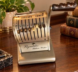 Vintage Paymaster Ribbon Writer check protector with metal body, sliding dollar and cent keys, and a side crank handle. Shows age-related wear and pat