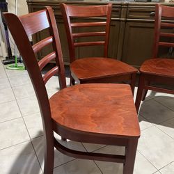 set of 3 mahogany colored wooded chairs