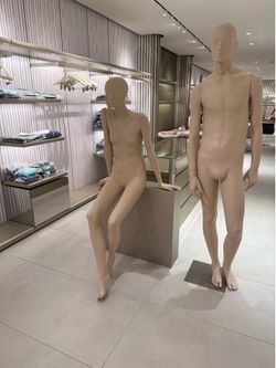 Couple male and female mannequins with sitting stand