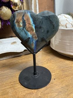 Flashy polished labradorite heart on a metal stand