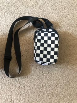 A checkered white and black poach bag