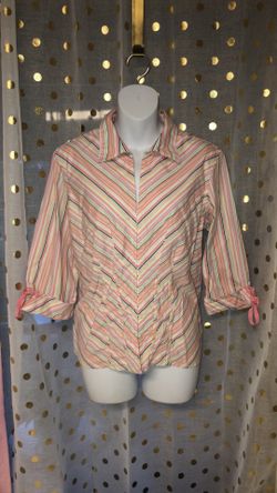 Size large pastel striped shirt that has ties at the sleeves and instead of buttons down the front, it has metal fasteners