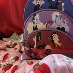The Loungefly Disney Villains Color Block Zip Around Wallet And Backpack