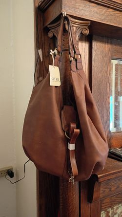 Brand new a n a new appearance JCPenney burgundy purse lota room all sales are final $70 tote bag burgundy color like red so it has tag on it two hand