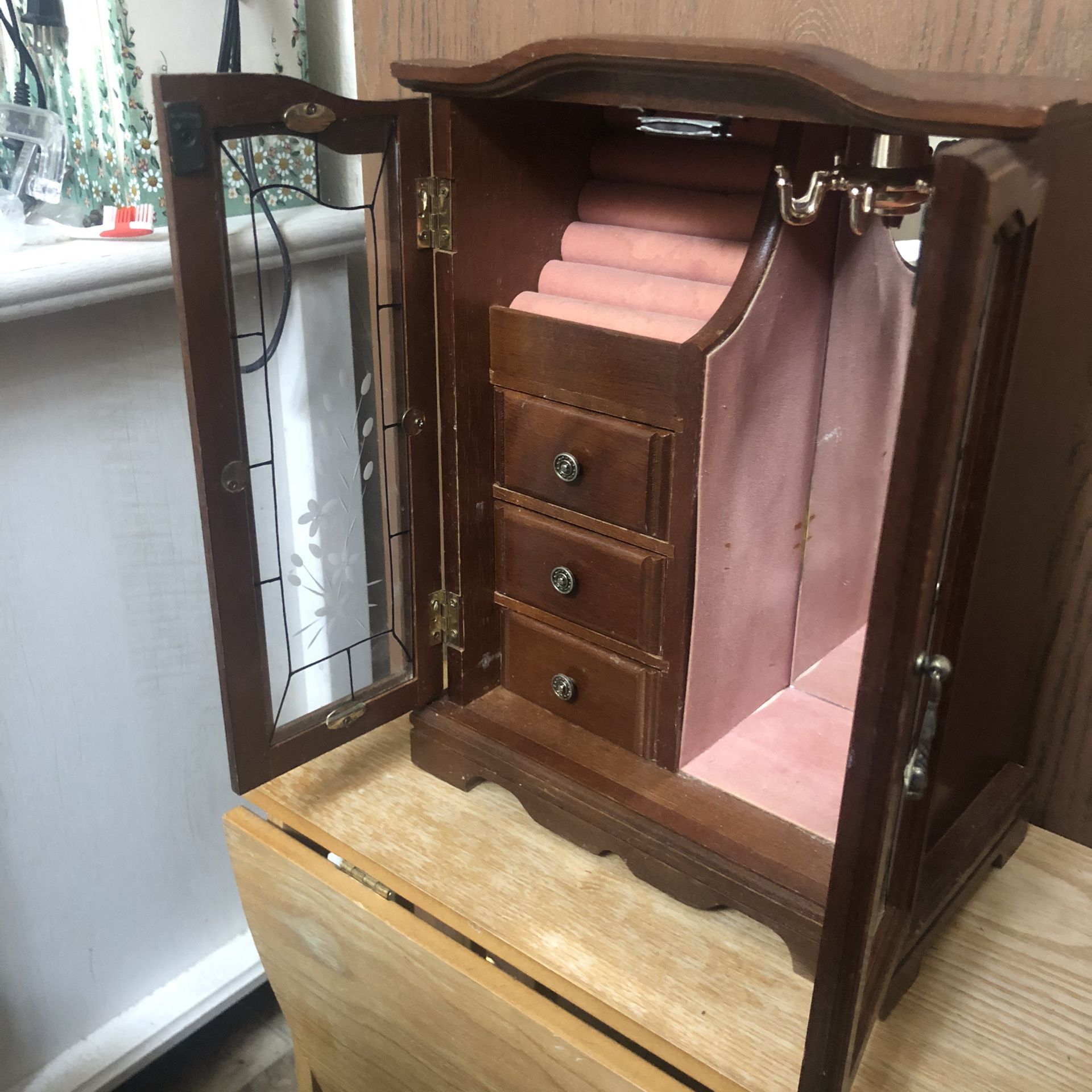 Vintage jewelry armoire with a music box