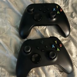 Two Black X Box Controllers