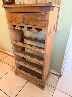 Mexican pine wine rack, which is a rustic, freestanding wooden unit