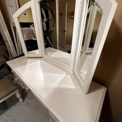 White vanity with mirror and bench