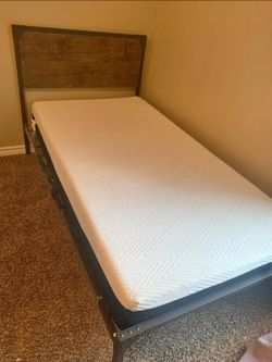 Twin-size bed frame with mattress in good condition.