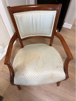 Sturdy cherry chair with rust stain on fabric