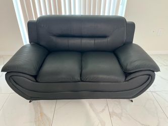 Two piece black leather sofa