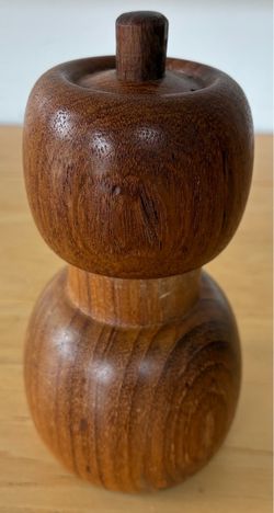 Wood salt shaker and pepper grinder combo.
