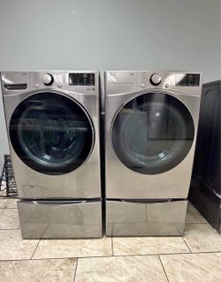 LG ThinQ front load washer &. LG Thinq gas dryer set with pedestals.