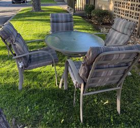 Outdoor table set with chairs and chair cushions