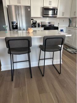 Two Counter Height grey chairs