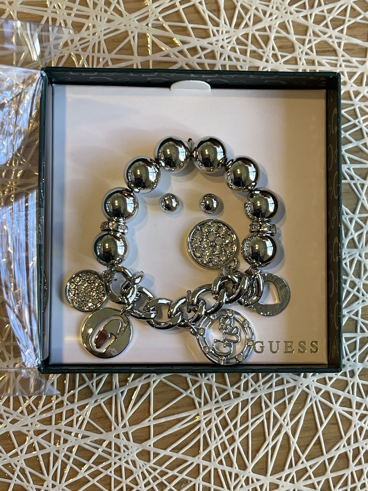 Guess charm bracelet and earring set in a BOX
