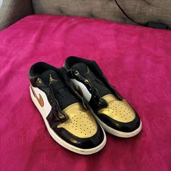 Gold and black jordans