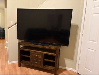 All wood tv stand and cabinet with a 75” Vizio tv
