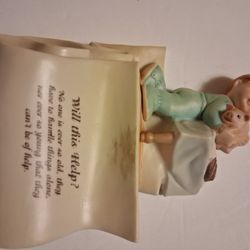 BABY ON A WALL HANGING PLAQUE
