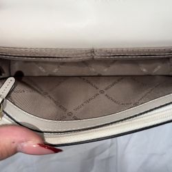 beige and gold MK purse