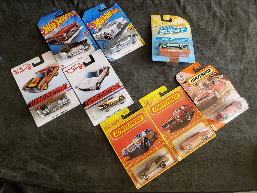 Assorted Hot Wheels and Matchbox toy cars.