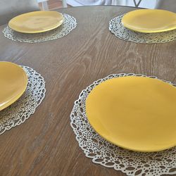 4 Yellow Crate and Barrel dinner plates and 4 placemats