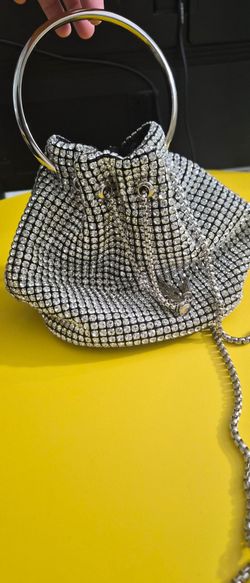 Stylish handbag with rhinestone design and metal handles.
