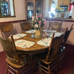 Oak Dining set with 6 chairs and Hutch with glass doors.