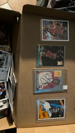 Box full of old basketball, baseball, football