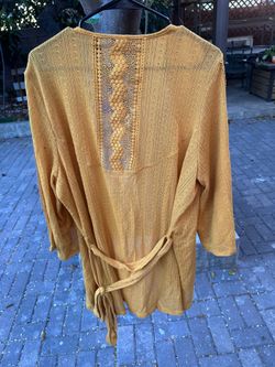 Flowy open-front crochet duster in a warm mustard tone. Soft, breathable knit with delicate lace panels. Easy layering piece for casual outfits. Size 