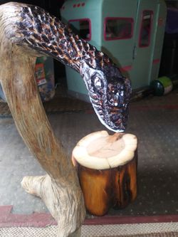 Hand carved snake necklace display.