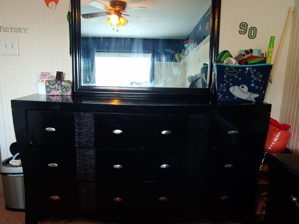Black dresser with mirror and nightstand