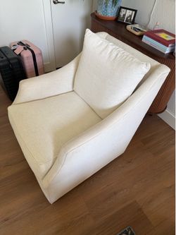 White upholstered cushion swivel chair