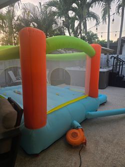 Inflatable bounce house with slide and attached ball pit. Includes electric blower and play balls. Inflates quickly and works well. Good for kids 3+. 