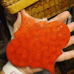 Antigue red arabesque-shaped Talavera tile. 