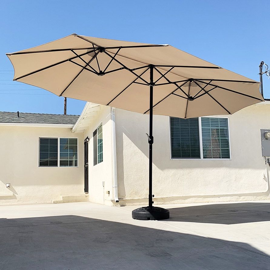 $130 (Brand New) Large 15 ft double sided outdoor umbrella with 65 lbs plastic weight base (beige color)