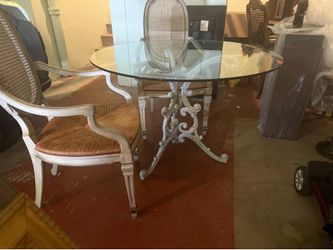 Glass table with pretty base and/w or w/o chairs.