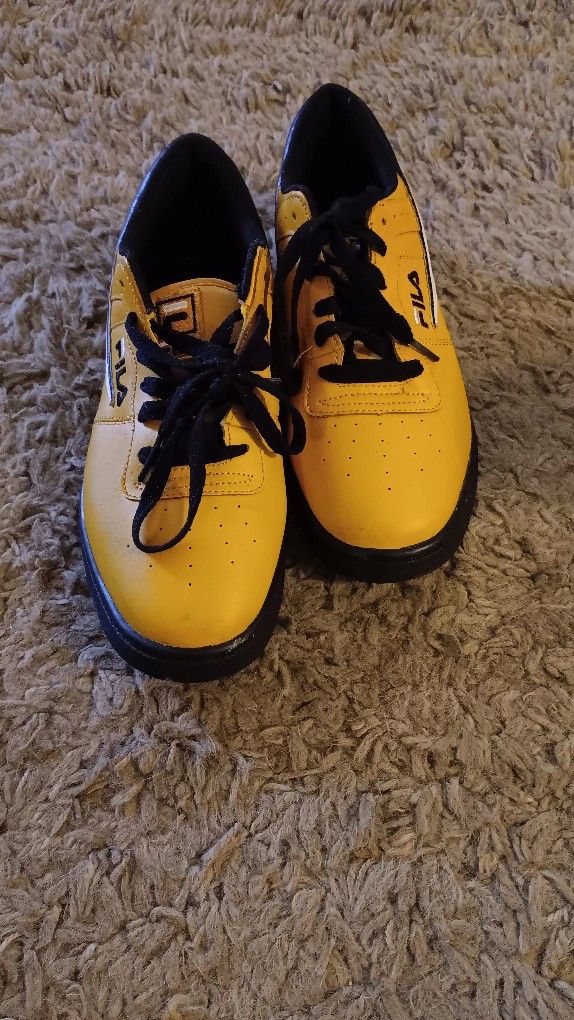 FILA yellow with black and white stripes tennis shoes size10 1/2