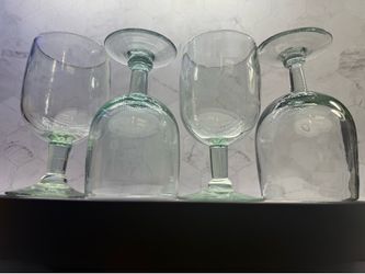 Set of (4) Beautiful handblown recycled glass goblets, featuring a distinct green or aqua tint from the manufacturing process.Material and Origin: The