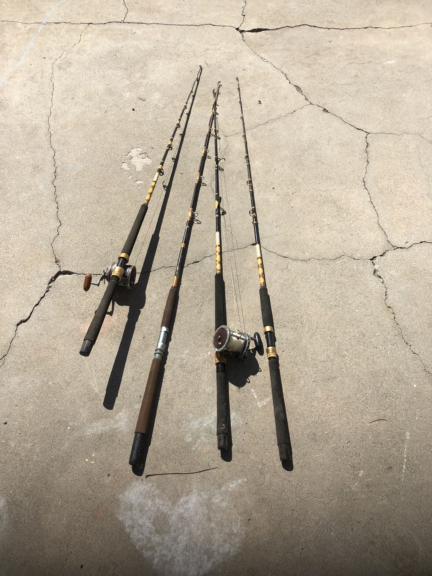 Four fishing rods and two old reels