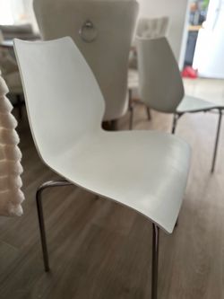 Two white chairs in good condition, no scratches, for $25 each.