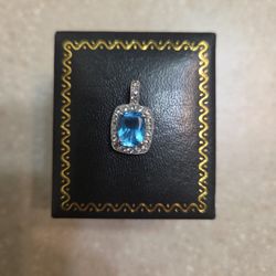 14 K White Gold Topaz And White Sapphires Pendant.  Weight Is 1.8 Grams 