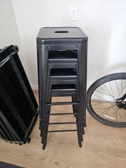 4 black metal bar stools
