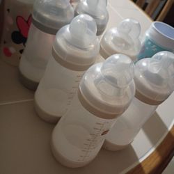 Monkey  Seat, Purple Highchair, Mickey Walker, And Assorted Baby Bottles 